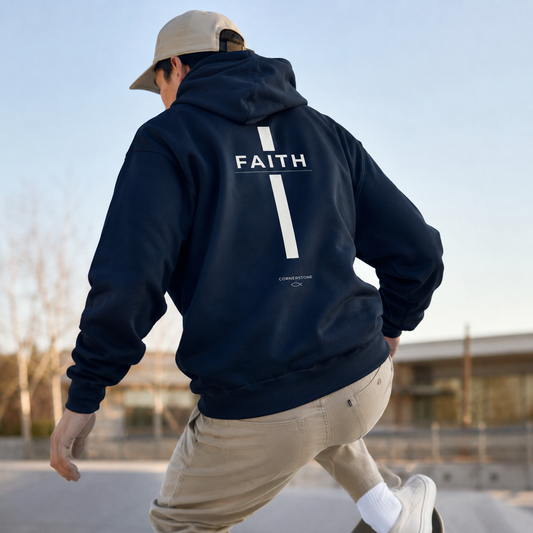 Person wearing a cornerstone wear navy hoodie with 'FAITH' printed on the back.