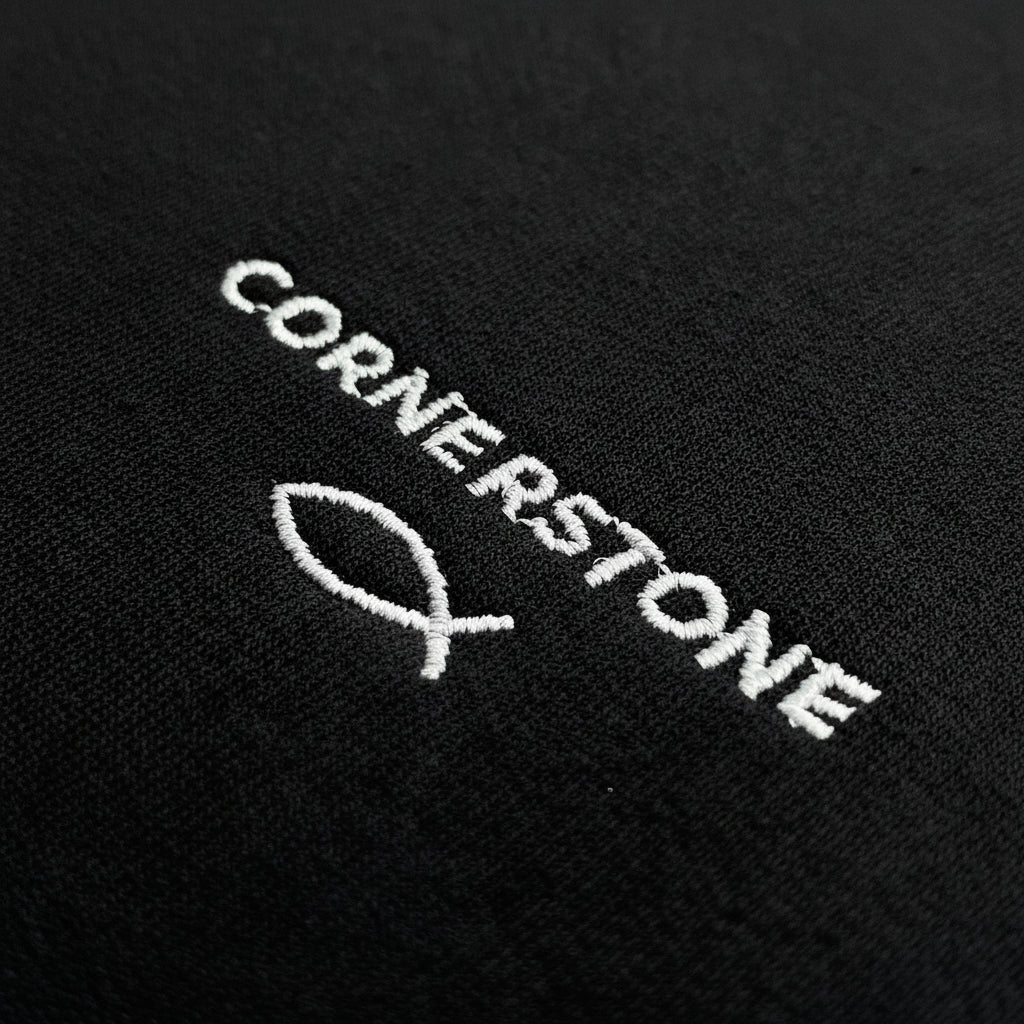 Cornerstone logo embroidered on a dark fabric surface