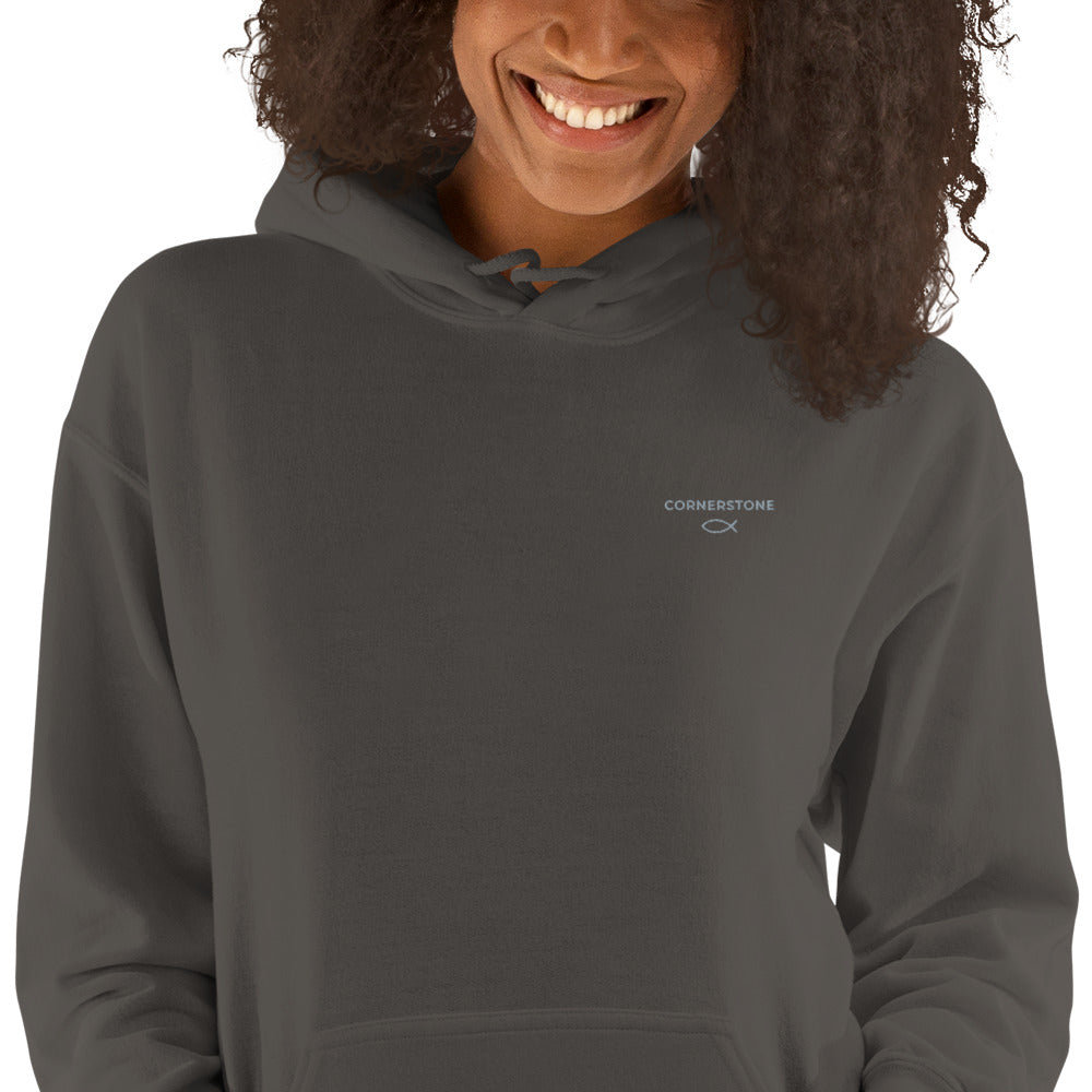 Cornerstone Wear unisex dark grey hoodie worn by woman, front view showing chest logo.