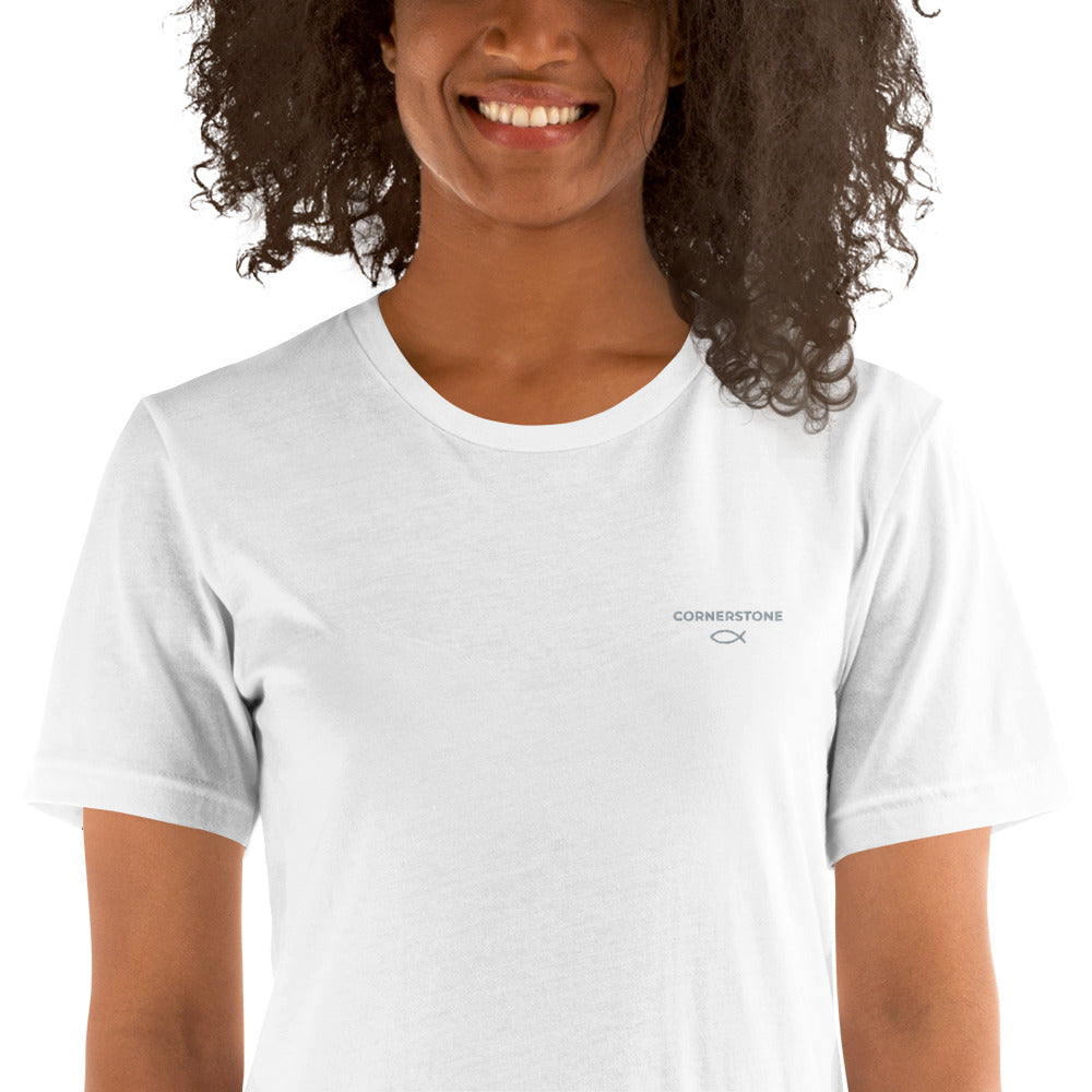 Cornerstone Wear unisex white t‑shirt worn by woman, front view.