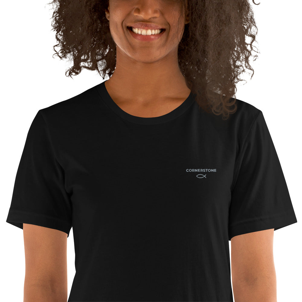 Cornerstone Wear unisex black t‑shirt worn by woman, front view.