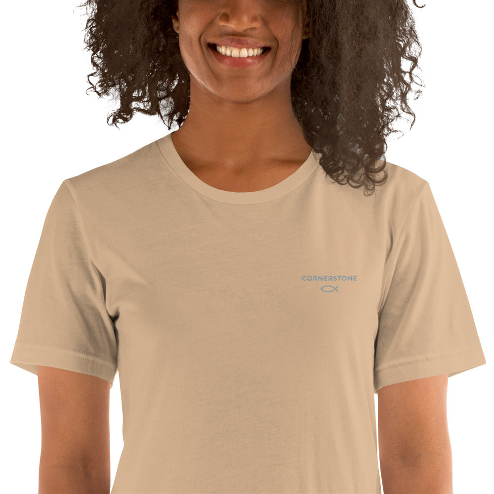 Cornerstone Wear unisex tan t‑shirt worn by woman, front view.